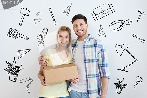 Image of smiling couple with box moving to new home