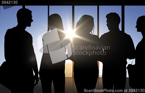 Image of people silhouettes over office background