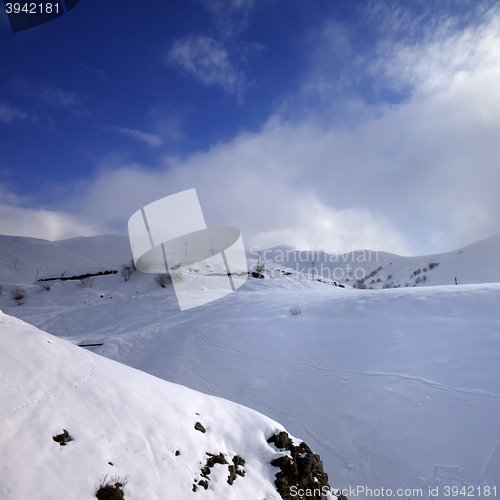 Image of View of off-piste slope and mountains in haze