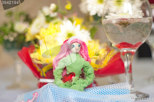 Image of Spring doll with red heart in hands