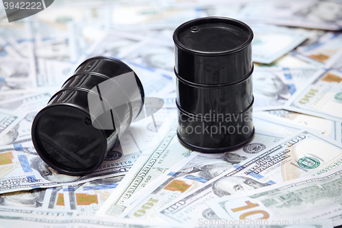 Image of Oil drums on US dollars background