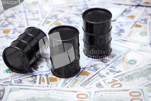 Image of Oil drums on US dollars background