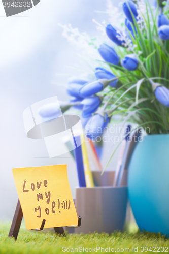 Image of Adhesive note with Love my job text at green office