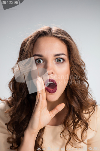 Image of Portrait of young woman with shocked facial expression