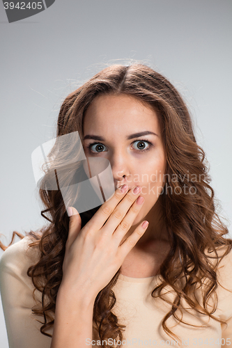 Image of Portrait of young woman with shocked facial expression