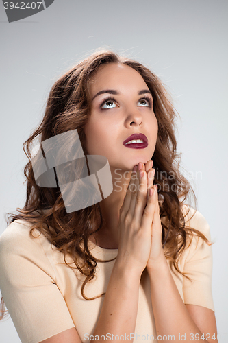 Image of Woman is looking imploring over gray background