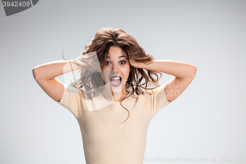 Image of Portrait of young woman with shocked facial expression