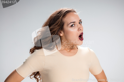 Image of Portrait of young woman with shocked facial expression