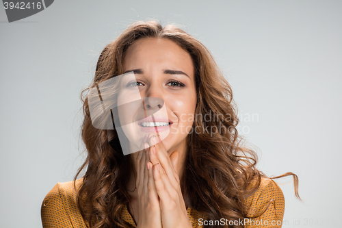 Image of Woman is looking imploring over gray background