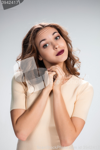 Image of Woman is looking imploring over gray background