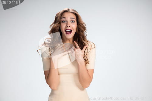 Image of Portrait of young woman with shocked facial expression