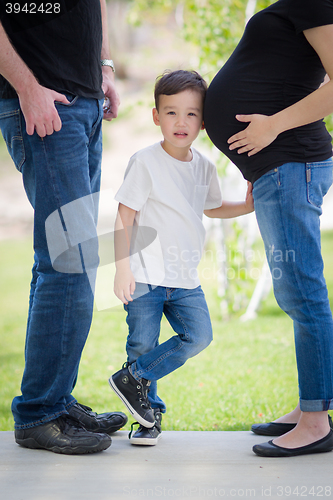 Image of Young Son With Ear on Pregnant Belly of Mommy