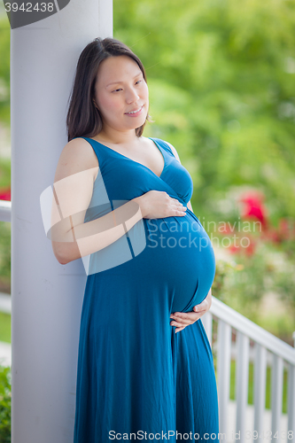 Image of Portrait of Young Pregnant Chinese Woman on the Front Porch