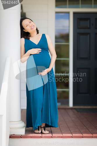 Image of Portrait of Young Pregnant Chinese Woman on the Front Porch