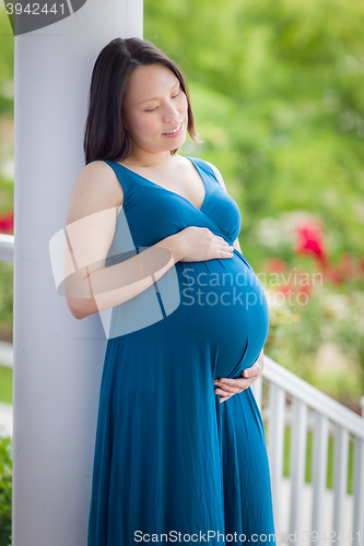 Image of Portrait of Young Pregnant Chinese Woman on the Front Porch