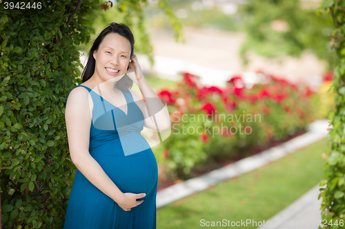 Image of Young Pregnant Chinese Woman Portrait in Park