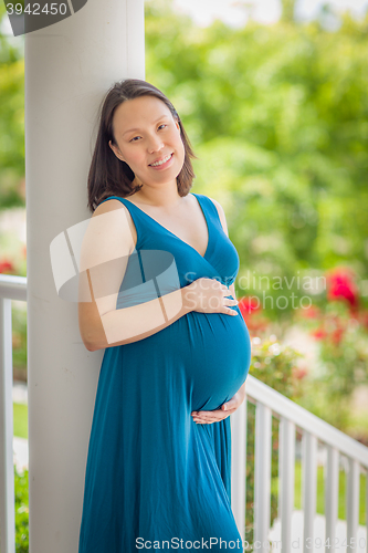 Image of Portrait of Young Pregnant Chinese Woman on the Front Porch