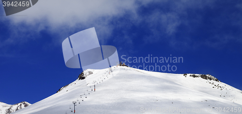 Image of Panoramic view on ropeway and ski slope in sun day