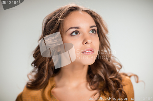 Image of The dreaming girl or woman on gray background