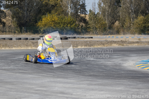 Image of Karting - driver in helmet on kart circuit