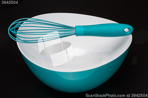 Image of Green silicone pastry brush and soup plate isolated on black