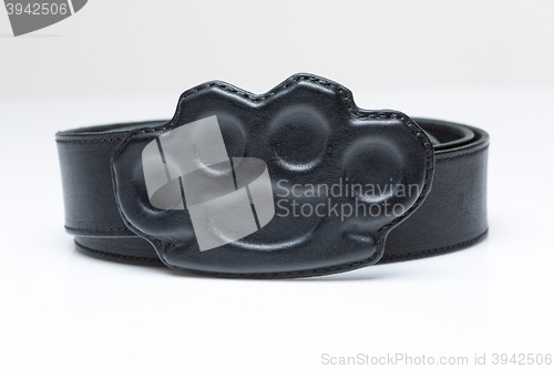 Image of black belt with a buckle in the form of brass knuckles