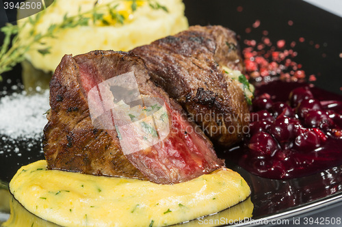 Image of plate of grilled meat with fries