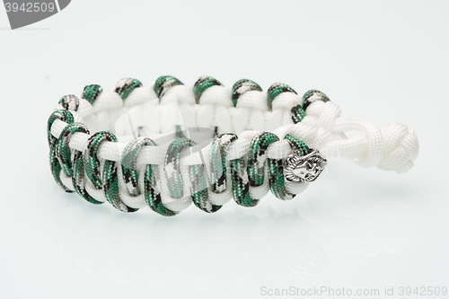 Image of green braided bracelet on white background