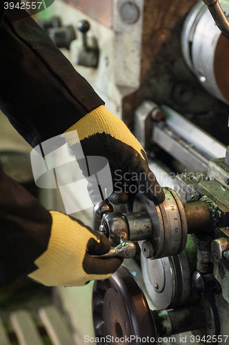 Image of worker in protective gloves