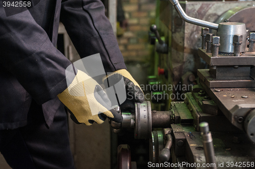 Image of worker in protective gloves