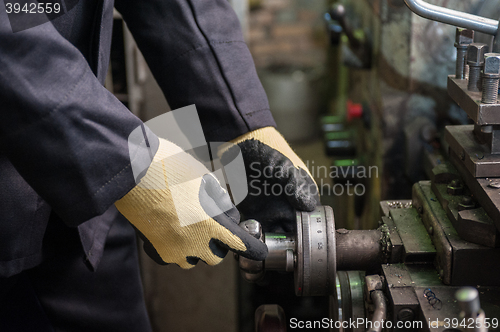 Image of worker in protective gloves