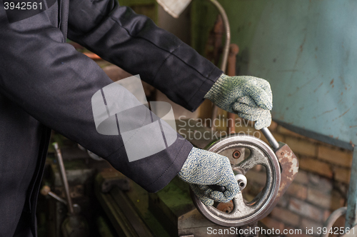 Image of worker in protective gloves