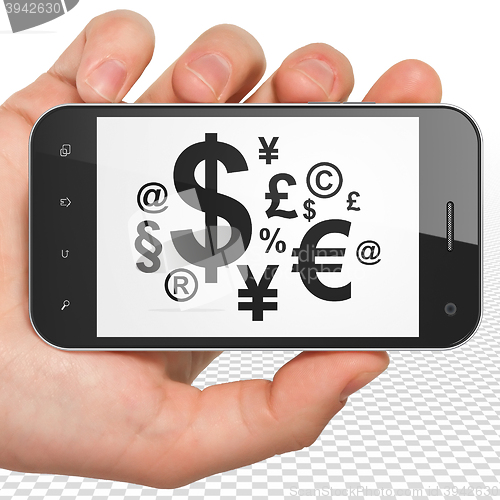 Image of News concept: Hand Holding Smartphone with Finance Symbol on display