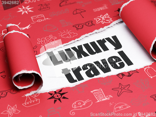 Image of Travel concept: black text Luxury Travel under the piece of  torn paper