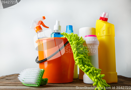 Image of Bucket with cleaning items on light background