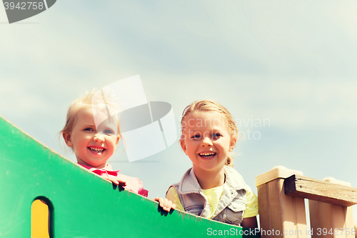 Image of happy little girls on children playground