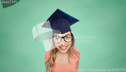 Image of smiling young student woman in mortarboard