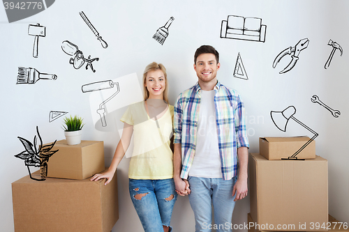 Image of smiling couple with big boxes moving to new home