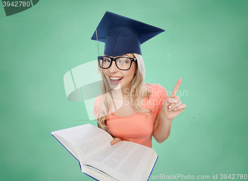 Image of student woman in mortarboard with encyclopedia