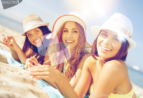 Image of girls sunbathing on the beach