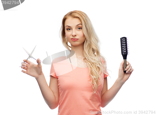 Image of young woman with scissors and hairbrush