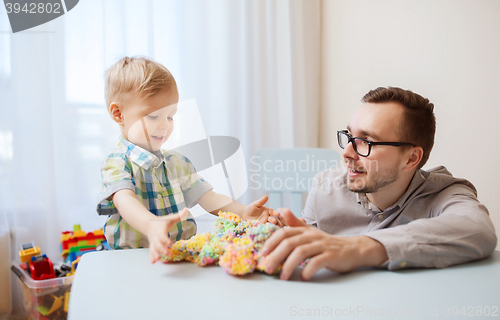 Image of father and son playing with ball clay at home