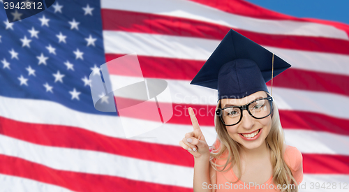 Image of smiling young student woman in mortarboard