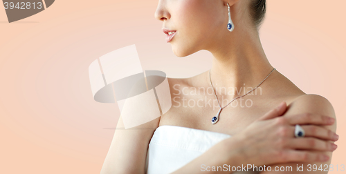 Image of beautiful woman with earring, ring and pendant