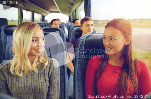 Image of happy young women talking in travel bus