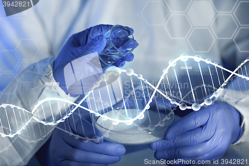 Image of close up of scientists hands with chemicals in lab