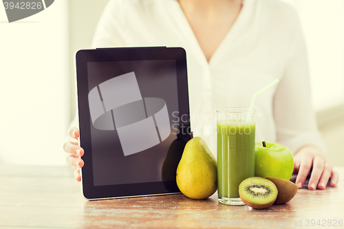 Image of close up of woman hands tablet pc and fruit juice