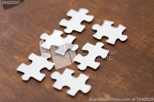 Image of close up of puzzle pieces on wooden surface