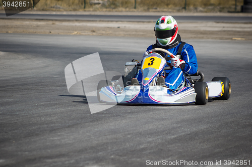 Image of Karting - driver in helmet on kart circuit