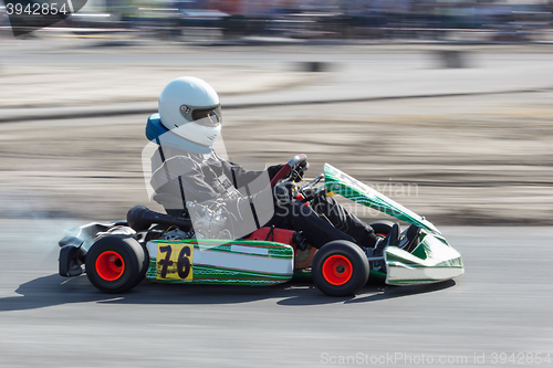 Image of Karting - driver in helmet on kart circuit